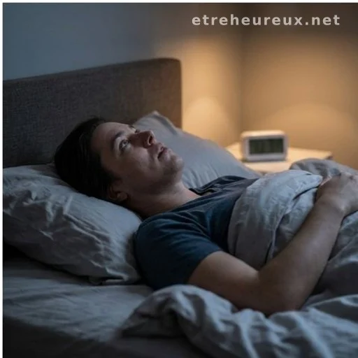 Person lying awake in bed at night unable to sleep